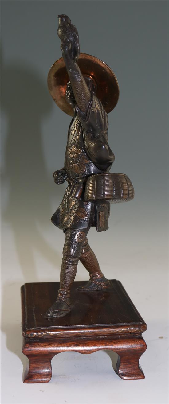 A Japanese two-colour bronze figure of a falconer, by Miyao, Meiji period, total height 26cm, lacking item to left hand